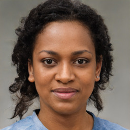 Joyful black young-adult female with medium  brown hair and brown eyes