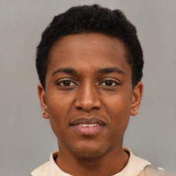 Joyful black young-adult male with short  black hair and brown eyes