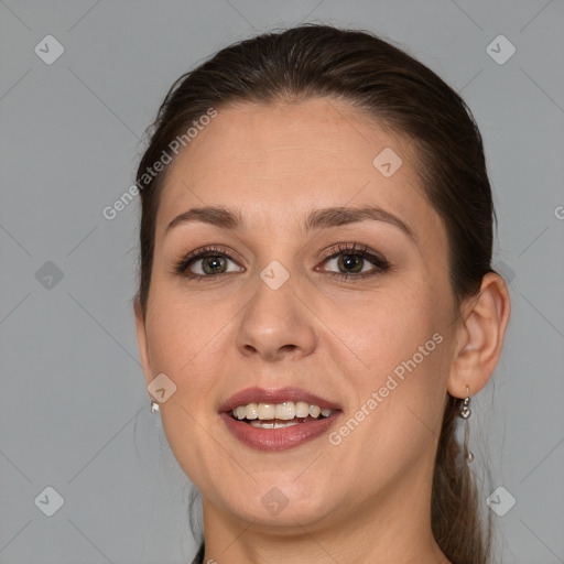 Joyful white adult female with medium  brown hair and brown eyes