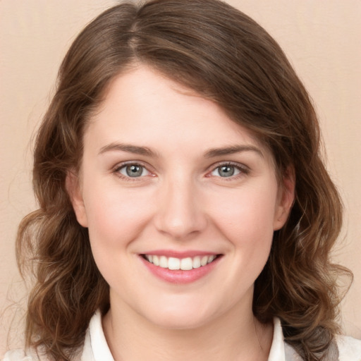 Joyful white young-adult female with medium  brown hair and green eyes