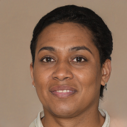 Joyful black adult female with short  brown hair and brown eyes