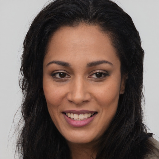 Joyful latino young-adult female with long  brown hair and brown eyes