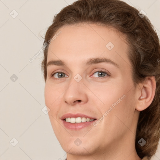 Joyful white young-adult female with medium  brown hair and green eyes