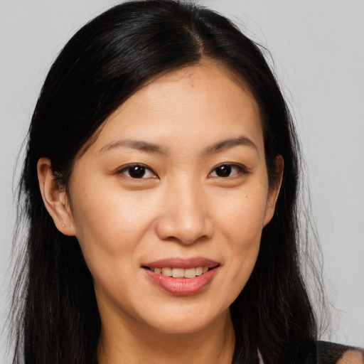 Joyful asian young-adult female with long  brown hair and brown eyes