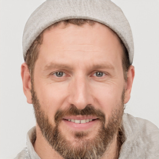 Joyful white adult male with short  brown hair and grey eyes