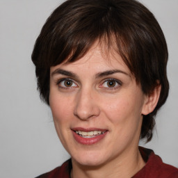 Joyful white adult female with medium  brown hair and brown eyes