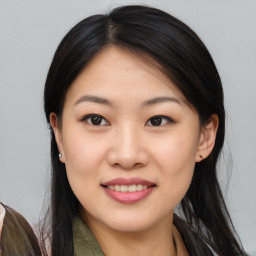 Joyful asian young-adult female with long  brown hair and brown eyes