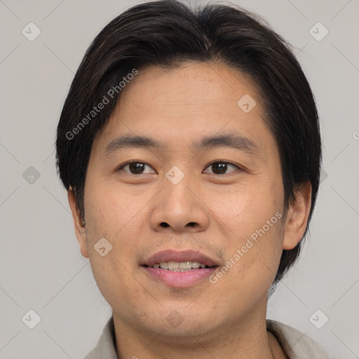 Joyful asian young-adult male with short  brown hair and brown eyes