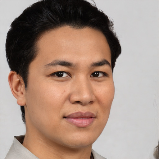 Joyful asian young-adult male with short  brown hair and brown eyes