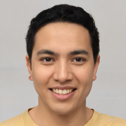 Joyful latino young-adult male with short  black hair and brown eyes