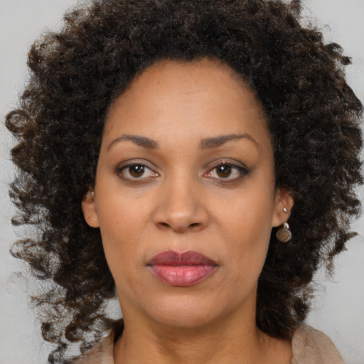 Joyful black young-adult female with medium  brown hair and brown eyes