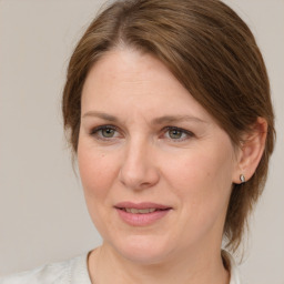 Joyful white adult female with medium  brown hair and grey eyes