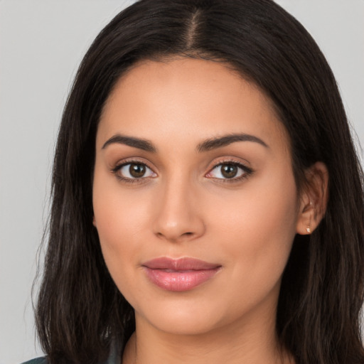 Joyful latino young-adult female with long  brown hair and brown eyes