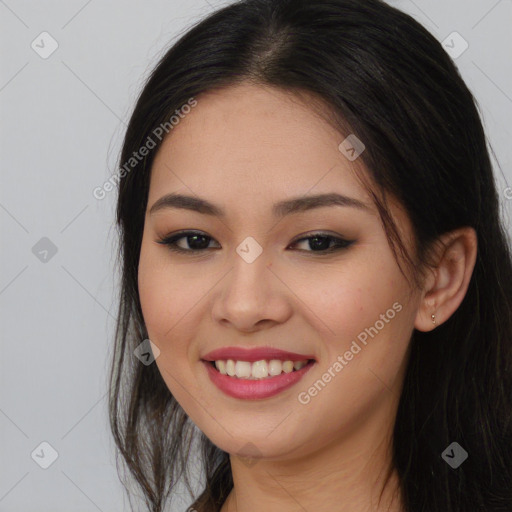 Joyful asian young-adult female with long  brown hair and brown eyes