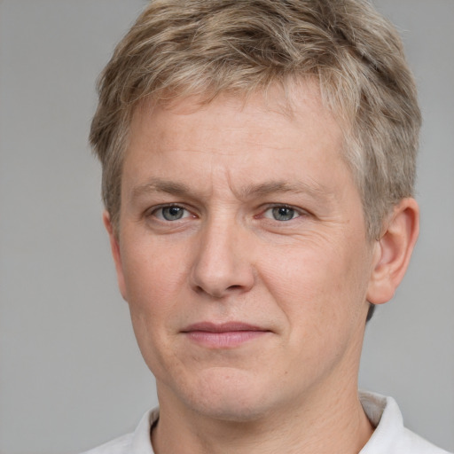 Joyful white adult male with short  brown hair and grey eyes