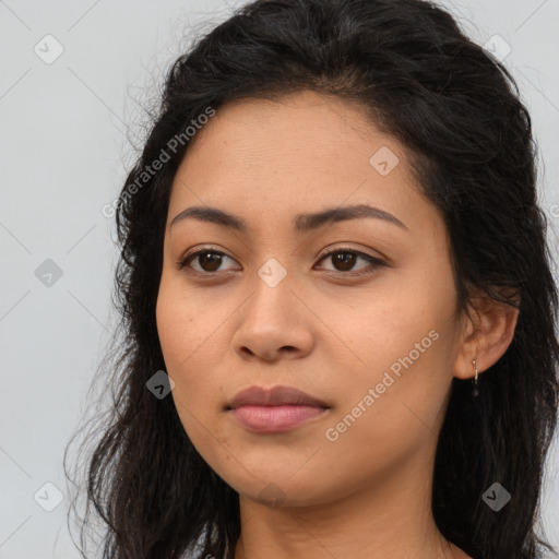 Joyful latino young-adult female with long  brown hair and brown eyes