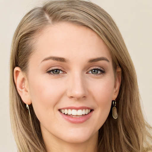 Joyful white young-adult female with long  brown hair and blue eyes