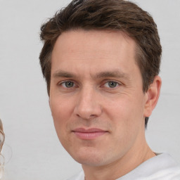 Joyful white adult male with short  brown hair and brown eyes