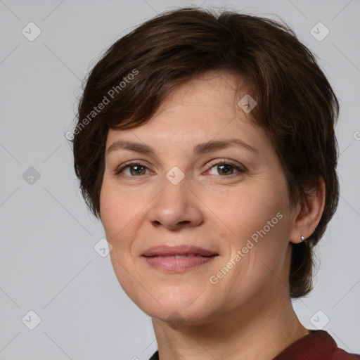 Joyful white adult female with medium  brown hair and brown eyes