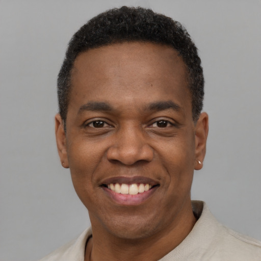 Joyful latino adult male with short  black hair and brown eyes