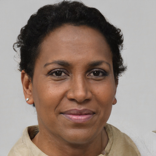 Joyful latino adult female with short  brown hair and brown eyes