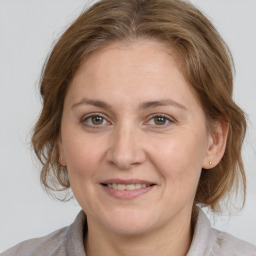 Joyful white adult female with medium  brown hair and brown eyes