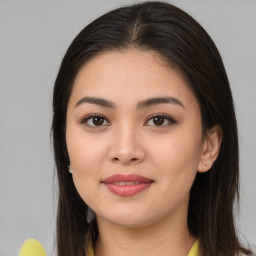 Joyful latino young-adult female with long  brown hair and brown eyes