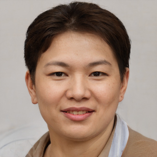 Joyful asian young-adult female with short  brown hair and brown eyes