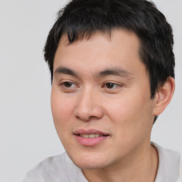 Joyful white young-adult male with short  black hair and brown eyes
