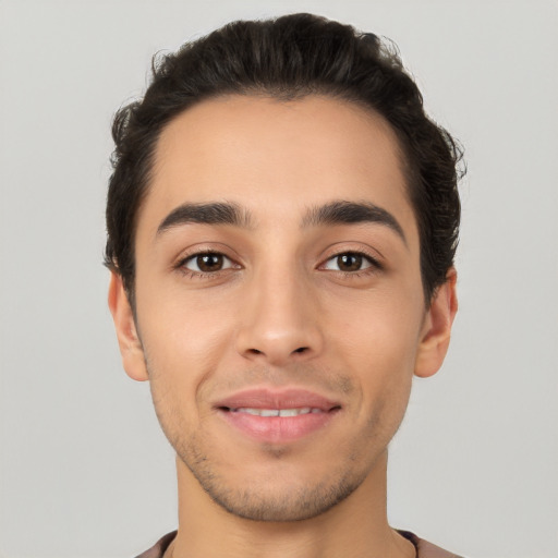 Joyful white young-adult male with short  black hair and brown eyes