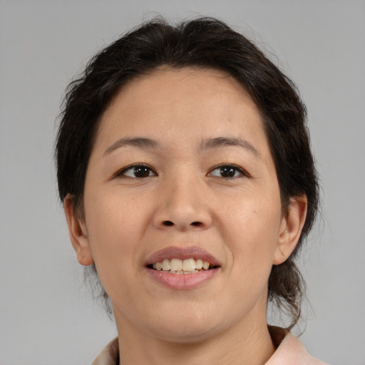 Joyful asian adult female with medium  brown hair and brown eyes