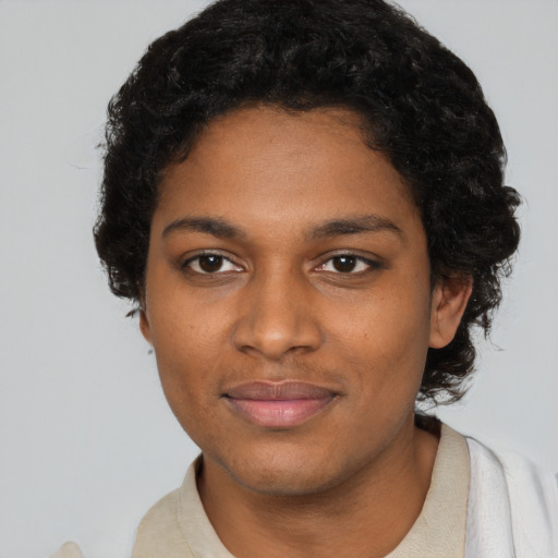 Joyful black young-adult female with short  black hair and brown eyes