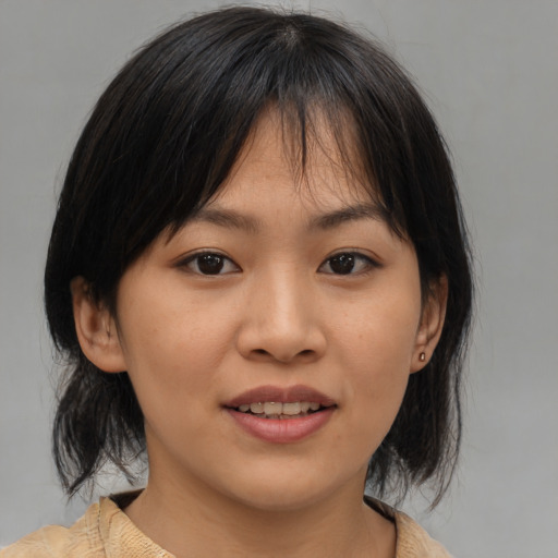Joyful asian young-adult female with medium  brown hair and brown eyes