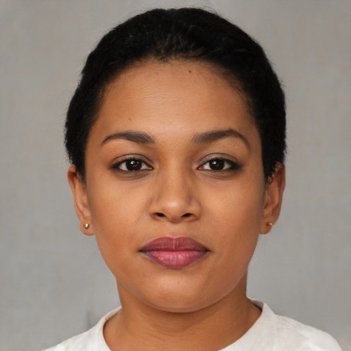 Joyful latino young-adult female with short  black hair and brown eyes