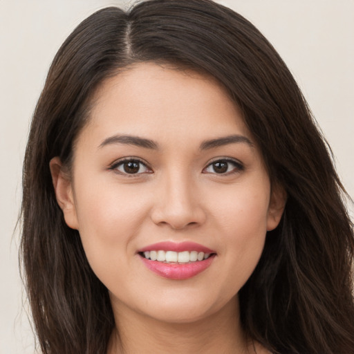 Joyful white young-adult female with long  brown hair and brown eyes