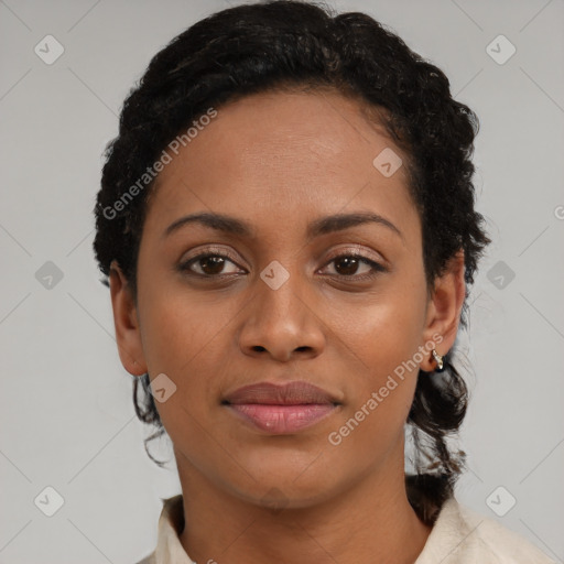 Joyful black young-adult female with short  black hair and brown eyes