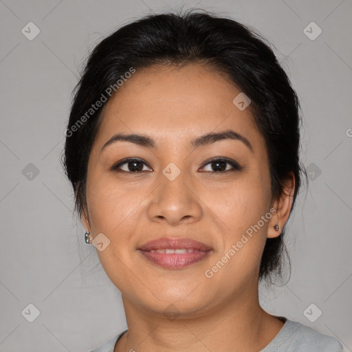 Joyful latino young-adult female with medium  brown hair and brown eyes