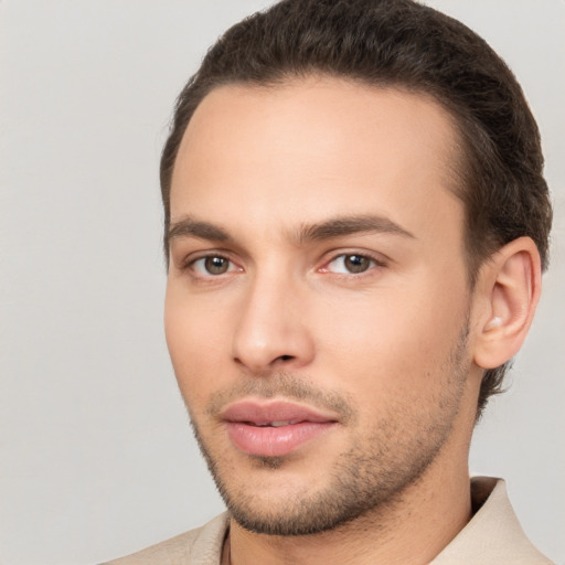 Joyful white young-adult male with short  brown hair and brown eyes