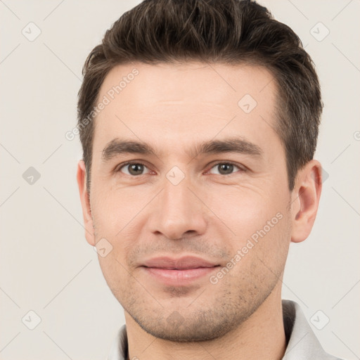 Joyful white young-adult male with short  brown hair and brown eyes