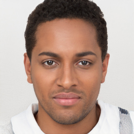 Joyful black young-adult male with short  brown hair and brown eyes