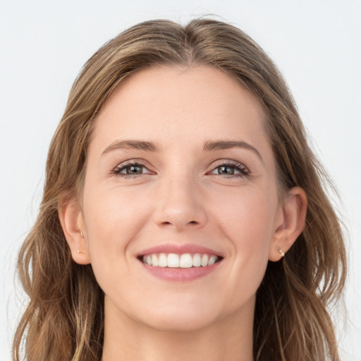 Joyful white young-adult female with long  brown hair and grey eyes