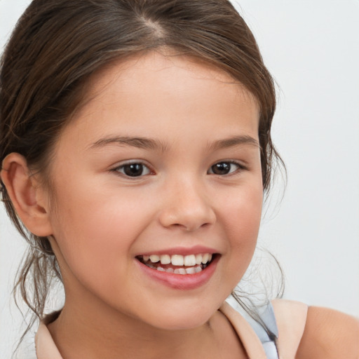 Joyful white child female with medium  brown hair and brown eyes