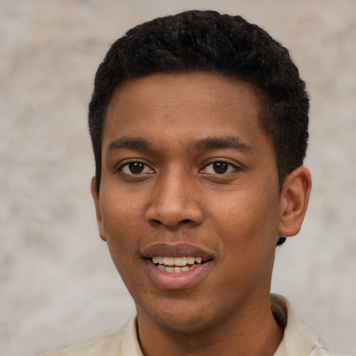 Joyful black young-adult male with short  black hair and brown eyes