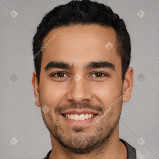 Joyful latino young-adult male with short  black hair and brown eyes