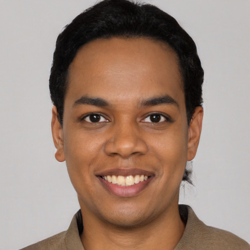 Joyful latino young-adult male with short  black hair and brown eyes