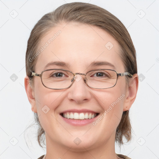 Joyful white adult female with medium  brown hair and grey eyes