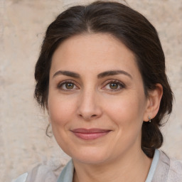 Joyful white adult female with medium  brown hair and brown eyes