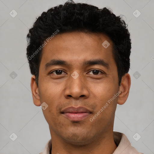 Joyful latino young-adult male with short  black hair and brown eyes