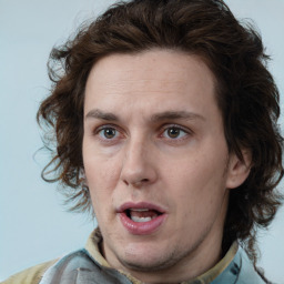 Joyful white adult male with medium  brown hair and brown eyes