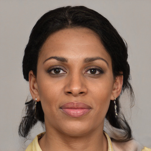 Joyful latino young-adult female with medium  black hair and brown eyes